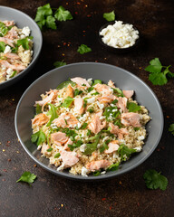 Salmon Couscous salad with feta cheese dressing and herbs. healthy food.