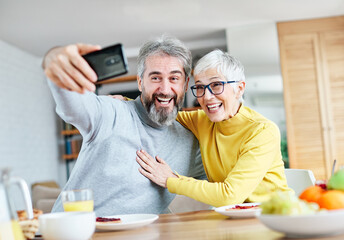 senior portrait woman man couple happy  retirement smiling love elderly lifestyle old together active healthy vitality hugging bonding romance having fun selfie camera smartphone mobile phone photo