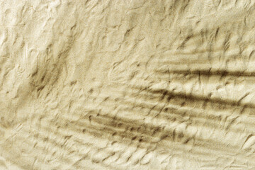 Natural fine sand stone texture with palm leaf shadow as background. Top view sand texture, sandy beach backdrop. Sunlight and shadows, summer sunny day, natural textured surface.