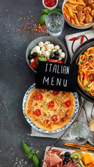 Italian food assortment on dark background.