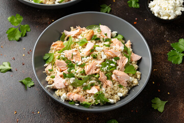Salmon Couscous salad with feta cheese dressing and herbs. healthy food.