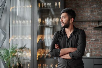 business owner standing in his wine shop.