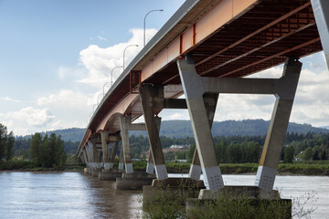 Mission Bridge over Fraser River during Sunny and Cloudy Spring Season Day. Fraser Valley, British Columbia, Canada.