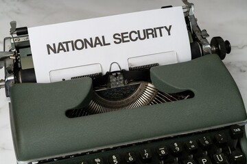 National security is written in large letters on a white piece of paper on an old army green...