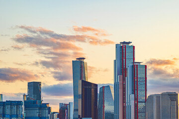 Fototapeta premium Cityscape of Yeouido skyscrapers in the business financial district taken in the evening sunset time in Seoul, South Korea