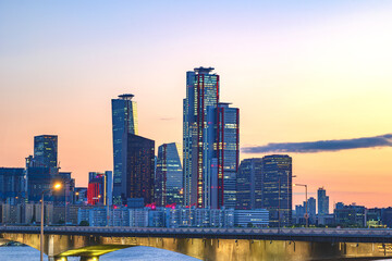 Fototapeta premium Cityscape of Yeouido skyscrapers in the business financial district taken in the evening sunset time in Seoul, South Korea