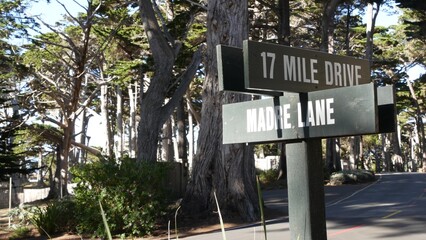 Scenic 17-mile drive wooden road sign, Monterey peninsula, Big Sur, California, USA. Coastal roadtrip, cypress forest. Pacific coast highway tourist route. Hitchhiking trip, ecotourism on vacations.