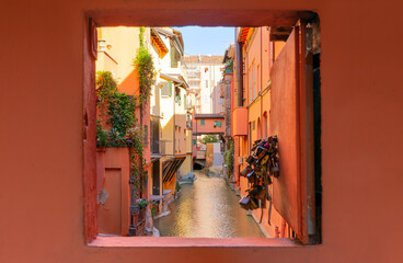 Secret window in the wall to the hidden part of the city in Bologna, Italy. Canal of Reno in Piella...
