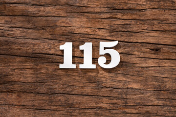Number 115 in wood, isolated on rustic background
