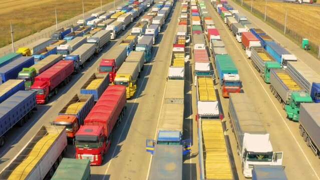 A huge queue of trucks loaded with grain crops in a blocked Ukrainian port. Humanitarian crisis due to the war.