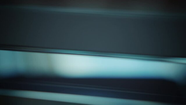 Abstract neon rays. Type of abstraction of rays in white-blue color neon light is reshaped through a glass prism, light is scattered through the edges of the glass.Movement of flow multi-colored rays.