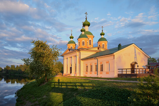 Summer landscape with an Orthodox church on the island, photo from bridge at sunset time.