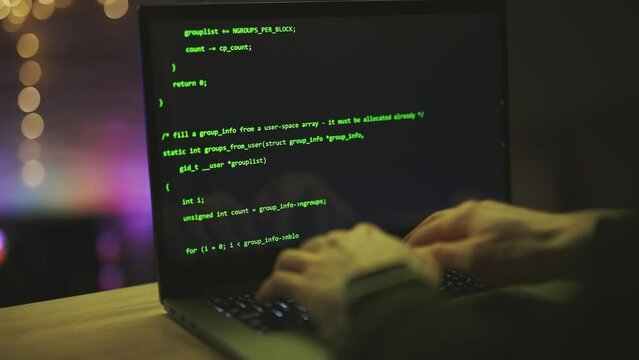 Close up of developing programming and coding technologies. Programmer hands are typing on keyboard. Software coder or blockchain developer at night. Concept of bitcoin cryptocurrency and wallet hack