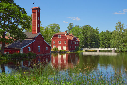 Attractions of Stromfors in Finland: red wooden buildings, old former plant, summer walk.