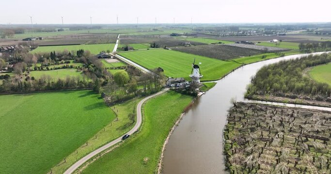 Aerial view of river Linge with road, mill and fruit orchards, Deil, Betuwe, Gelderland, Netherlands