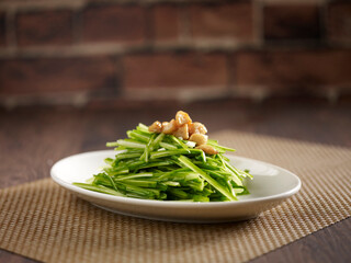 Stir-fried Chinese Chive served in a dish isolated on mat side view on dark background