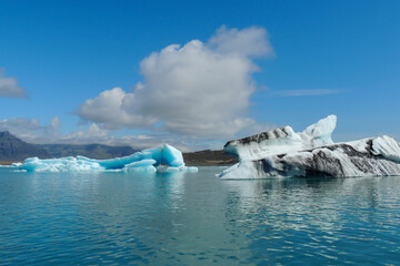 Bright clear blue iceberg floating in the Jokulsarlon lake blue cold water in Iceland 50