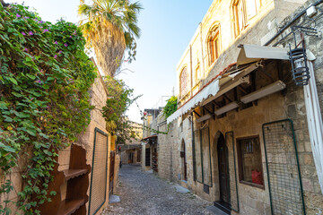 Narrow street among the stone houses of the ancient city of Rhodes on the island of Rhodes, Greece
