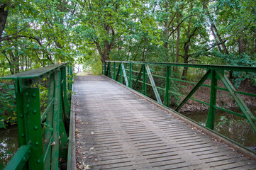 Old green iron bridge over the river in South Bohemia