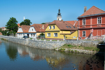 Fototapeta na wymiar Sobeslav, Czech Republic: River embankment with old colorful houses.