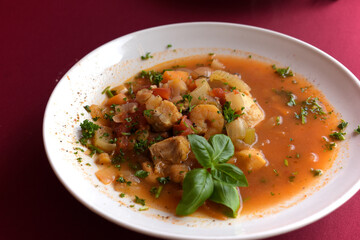 Bouillabaisse soup on a white plate