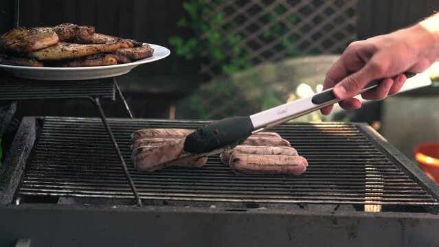 Spicy Sausages Being Grilled Over Bright Glowing Coals Broasting On Fire. Lunch Celebration Party Barbecue. Outdoor Cooking. Cook Prepares Oriental Dish In Kitchen. Junk Food, Healthy Lifestyle.
