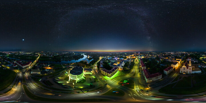 aerial seamless spherical 360 night panorama overlooking old town, urban development, historic buildings, crossroads with bridge across river with stars and milky way in equirectangular projection