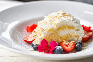 meringue roll with strawberries, blueberries, raspberries and cranberries. Dessert decorated with fresh berries
