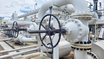 Valves on the petrochemical tank farm with pipelines