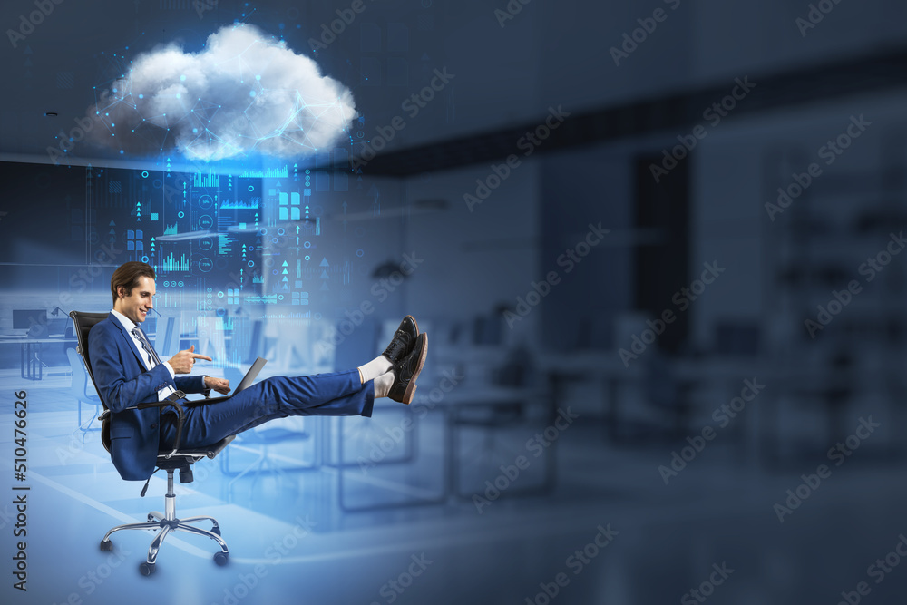 Poster businessman pointing at laptop while relaxing in swivel-chair in blurry office interior with abstrac