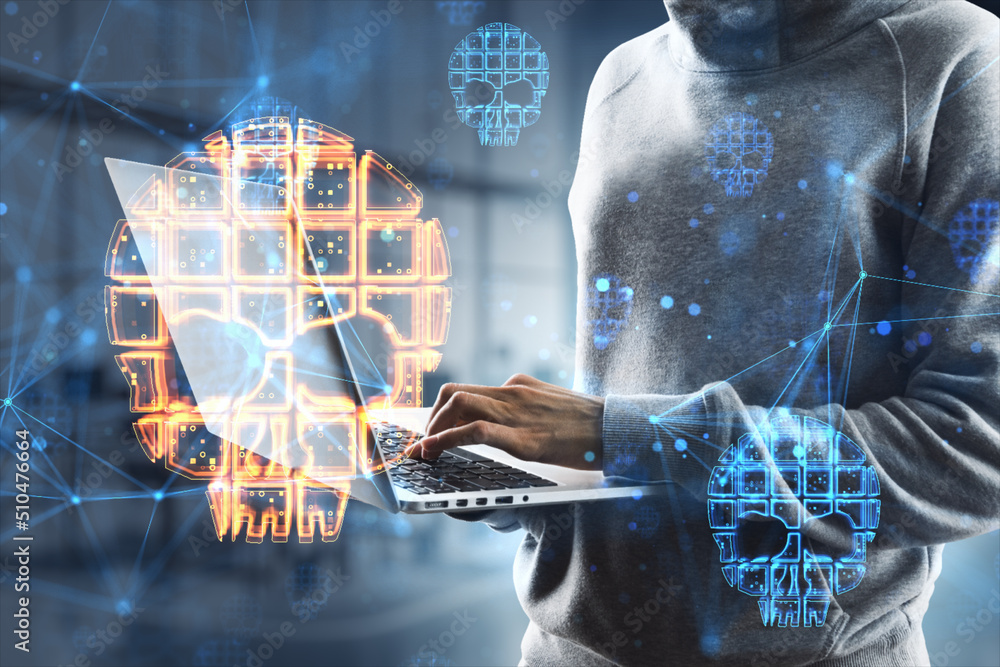 Poster close up of hacker hands using laptop with skull hologram on blurry office interior background. dang