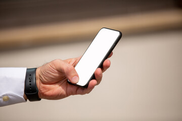 Male hand holding mobile phone. blank background