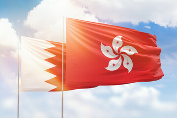 Sunny blue sky and flags of hong kong and bahrain