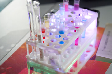 A set of laboratory utensils for medical or scientific research. A beaker with chemicals. Laboratory glass equipment, test tubes and flasks. High quality photo