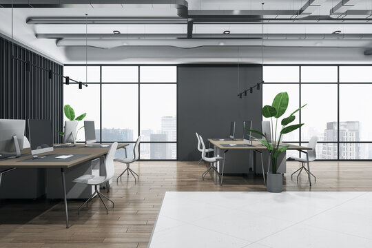 Side view on cozy workspaces in coworking office with city view from big windows, wooden and white ceramic floor, green plants and modern computers on brown tables. 3D rendering