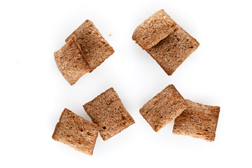 Set of chocolate pillows for breakfast isolated on white background. Brown choco cereal pads with vanilla, crispy flakes, healthy sweet snack. Close-up