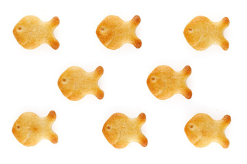 Yellow fish crackers on isolated white background. Close-up.