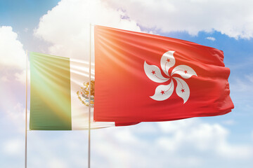 Sunny blue sky and flags of hong kong and mexico