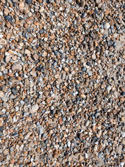 Small wet colourful pebble texture on the ocean beach