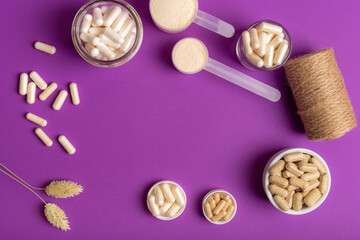 Fototapeta na wymiar Multivitamin capsules and minerals to support to maintain a high level of human immunity and good health. Composition with organic food supplements on purple background from above.