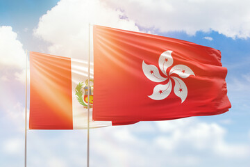 Sunny blue sky and flags of hong kong and peru