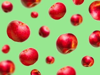 Flying levitating floating red ripe fresh juicy apples in air on green background. Levity summer fruits. Trendy, minimal,creative food.healthy nutrition
