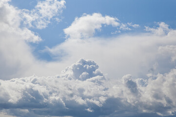Clouds in the blue sky. Background, blue sky with cumulus clouds.