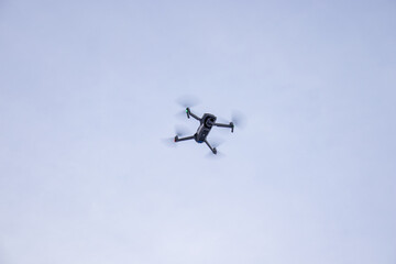 Naklejka na ściany i meble Small drone with good camera flying in the air for demonstration reference photo 