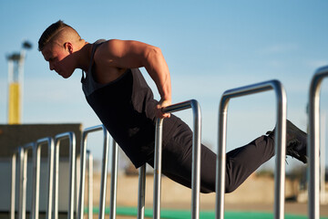 Young male athlete using hurdle to work out