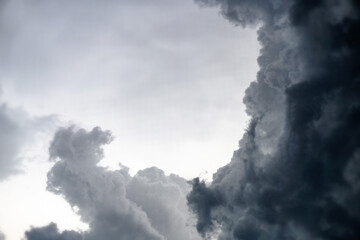 Dark, gloomy, stormy, rainy sky with rays of light. Terrible hurricane clouds. Background image for design