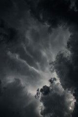 Dark, gloomy, stormy, rainy sky with rays of light. Terrible hurricane clouds. Background image for design