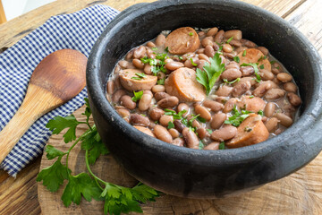 detail of feijoada with feijão manteiga (brazilian brown bean) with vegan pepperoni
