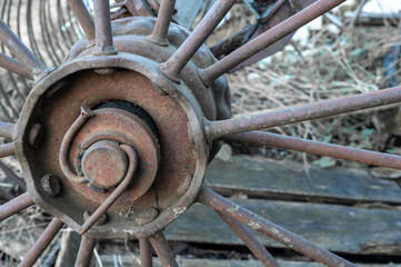 Old round rusty wheel agricultural machinery. Steampunk spokes. High quality photo