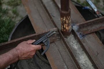 Manual welding. A man's hand on a metal background
